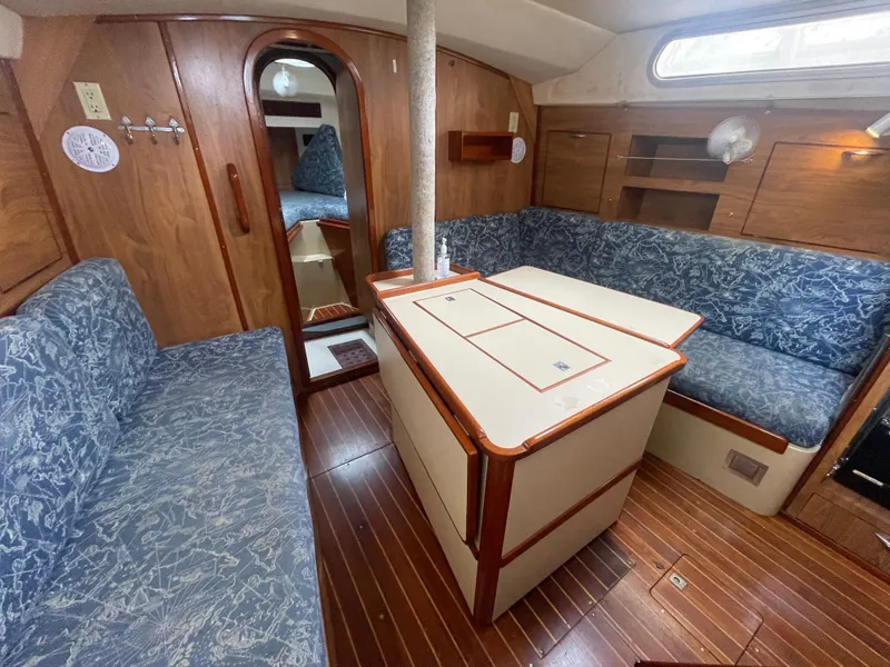 Slide: The Image of 1979 Moody 36 Classic yacht interior with wood finish and blue upholstery. - 45
