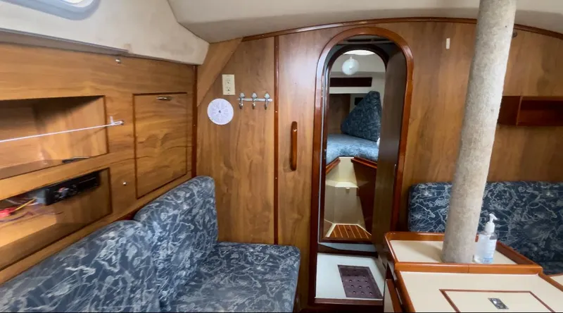 Slide: The Image of Interior of 1979 Moody 36 Classic sailboat with wood paneling and cozy seating. - 46