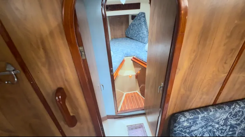 Slide: The Image of Interior of 1979 Moody 36 Classic sailboat with wooden finish and cozy cabin. - 47
