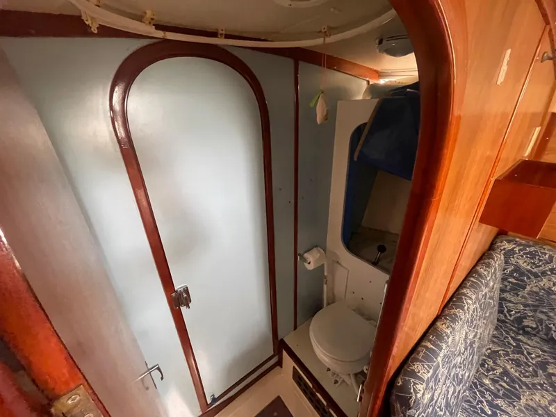 Slide: The Image of 1979 Moody 36 Classic yacht bathroom with wooden accents and compact design. - 49