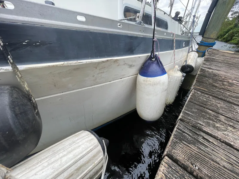 Slide: The Image of 1979 Moody 36 Classic yacht docked with fenders, wooden pier visible. - 5
