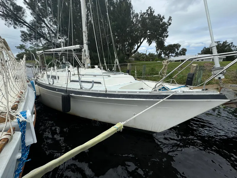Slide: The Image of 1979 Moody 36 Classic sailboat docked by the shore. - 6