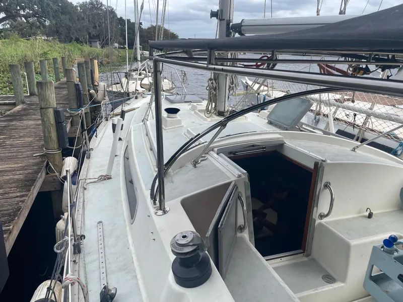 Slide: The Image of 1979 Moody 36 Classic sailboat docked by a wooden pier, overcast sky. - 9