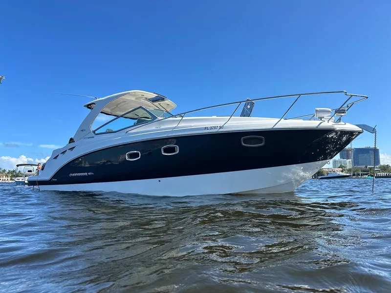 Slide: The Image of 2014 Chaparral 330 Signature boat on water under clear blue sky. - 0
