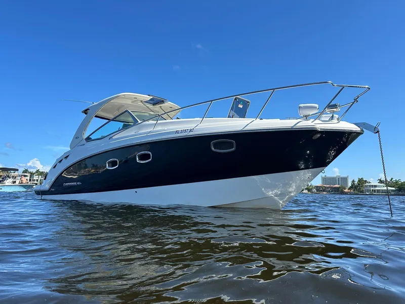Slide: The Image of 2014 Chaparral 330 Signature boat on water under clear blue sky. - 11