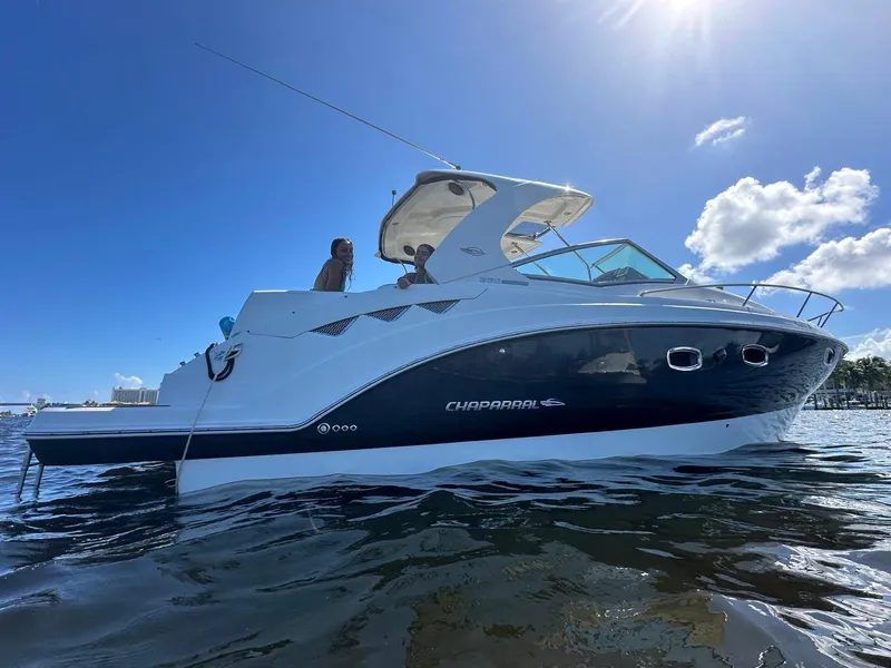 Slide: The Image of 2014 Chaparral 330 Signature boat on water under clear blue sky. - 2