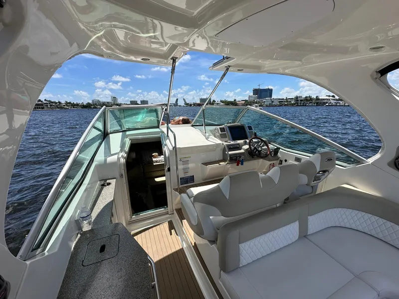 Slide: The Image of 2014 Chaparral 330 Signature boat interior with helm, seating, and waterfront view. - 4
