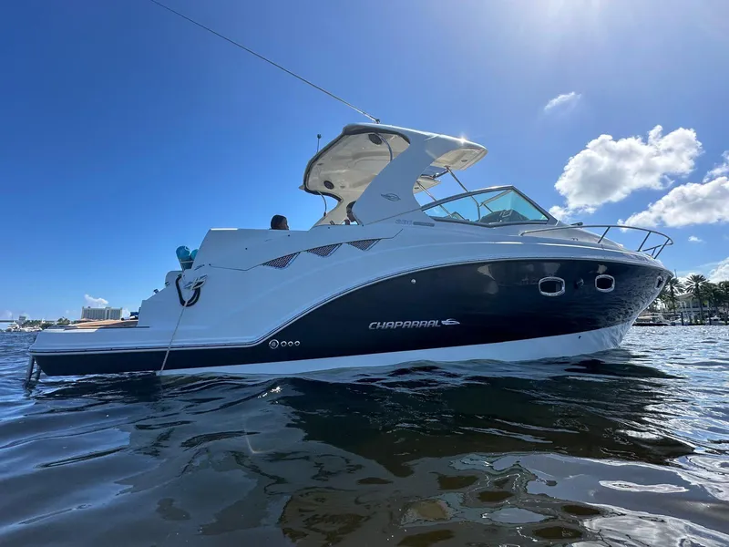 Slide: The Image of 2014 Chaparral 330 Signature boat on water under clear blue sky. - 7