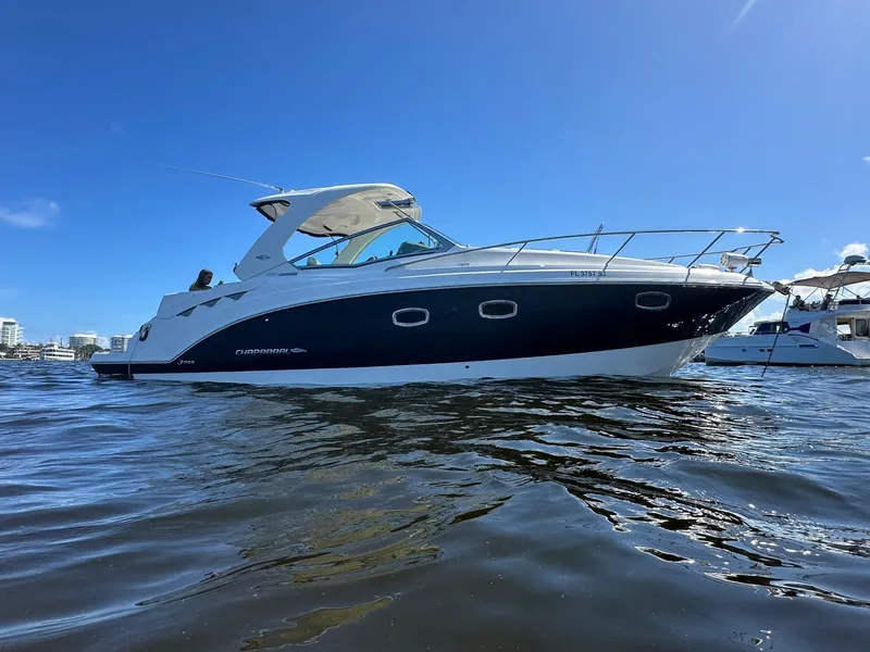 Slide: The Image of 2014 Chaparral 330 Signature boat on water under clear blue sky. - 9