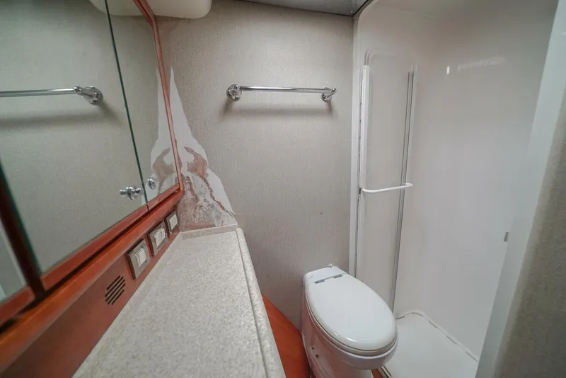Slide: The Image of Bathroom interior of 2007 Bertram 510 Convertible yacht, featuring shower and toilet. - 12