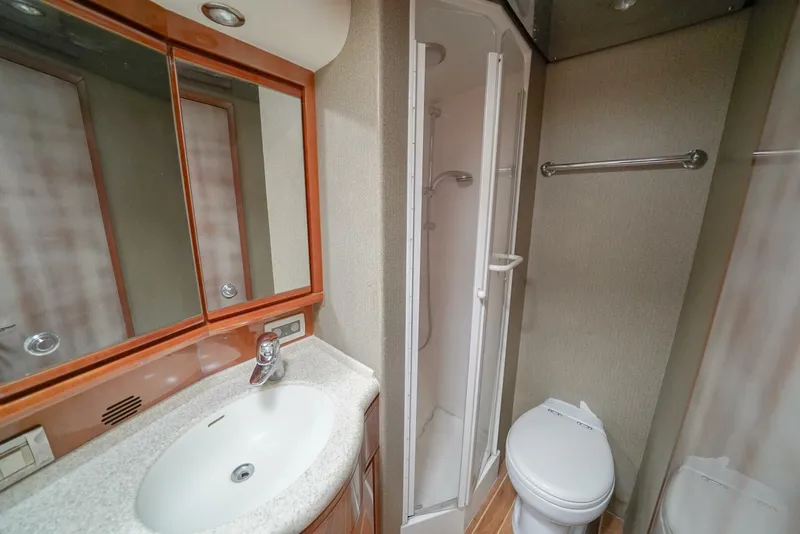 Slide: The Image of Bathroom interior of 2007 Bertram 510 Convertible yacht, featuring sink, shower, and toilet. - 14