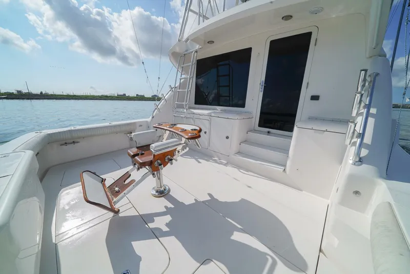Slide: The Image of 2007 Bertram 510 Convertible yacht deck with fishing chair, ocean view, and clear sky. - 22