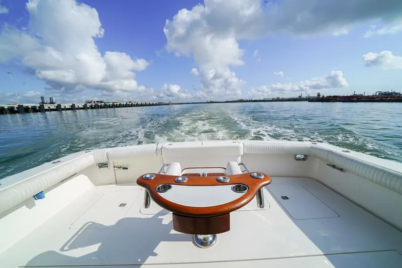 Slide: The Image of 2007 Bertram 510 Convertible boat cruising on open water under a blue sky. - 23