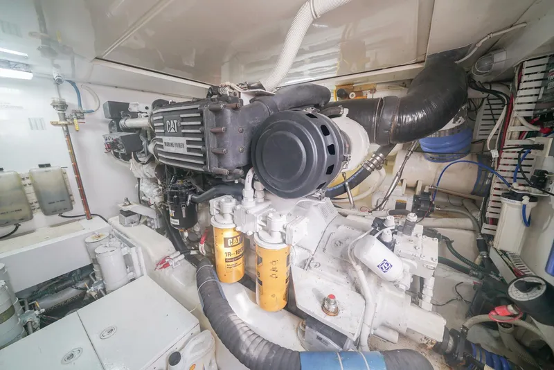 Slide: The Image of Engine room of a 2007 Bertram 510 Convertible yacht, featuring a CAT marine engine. - 26