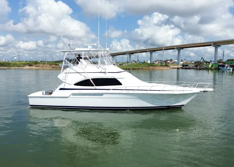 Slide: The Image of 2007 Bertram 510 Convertible yacht on calm water under a cloudy sky. - 36