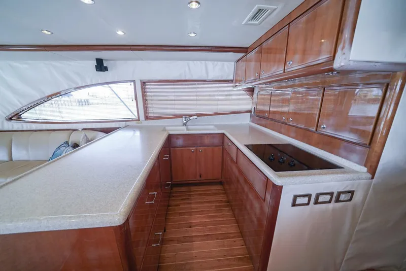 Slide: The Image of Interior of 2007 Bertram 510 Convertible yacht with modern kitchen and wooden cabinetry. - 5