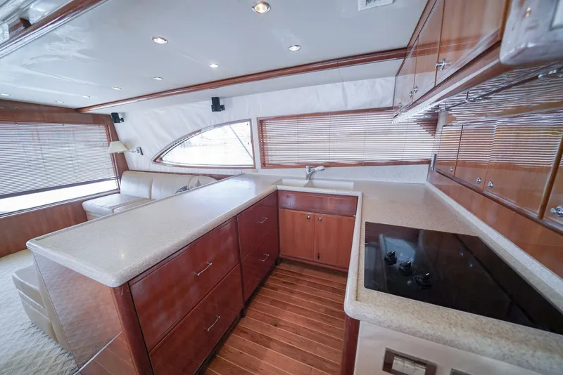 Slide: The Image of Luxurious kitchen interior of 2007 Bertram 510 Convertible yacht with wood cabinetry and modern appliances. - 6