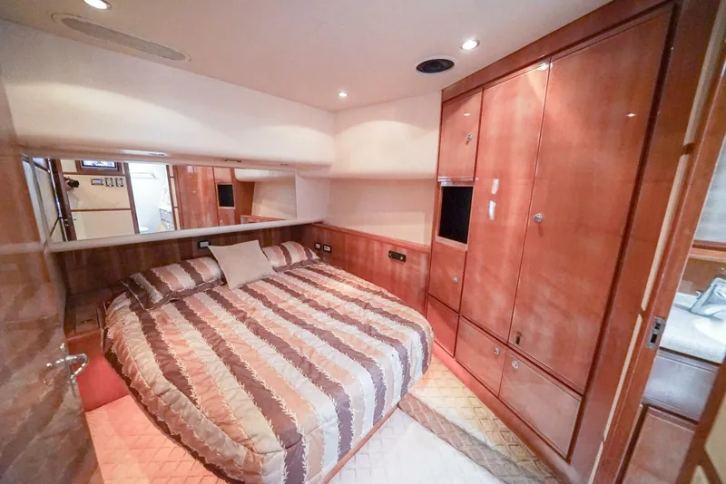 Slide: The Image of Luxurious bedroom interior of 2007 Bertram 510 Convertible yacht with wood paneling. - 9