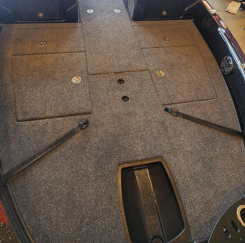 Slide: The Image of 2024 Nitro ZV21 boat interior with carpeted deck and storage compartments. - 1