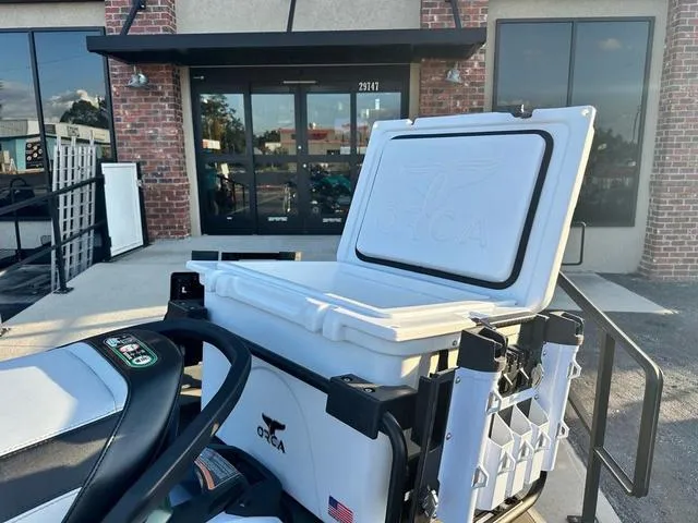 Slide: The Image of 2025 Kawasaki Jet Ski Ultra 160 with Orca cooler, parked outside a brick building. - 8