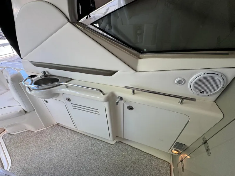 Slide: The Image of Interior view of a 2006 Sea Ray 38 Sundancer yacht, featuring a sleek kitchenette area. - 14
