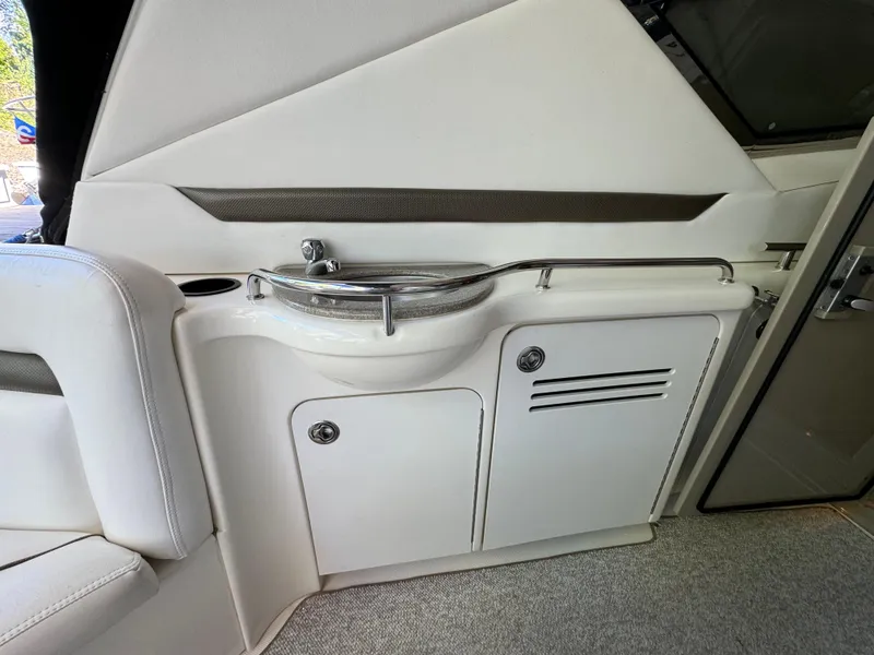 Slide: The Image of 2006 Sea Ray 38 Sundancer interior with compact sink and storage cabinets. - 15