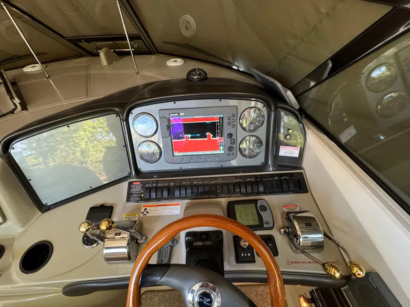 Slide: The Image of 2006 Sea Ray 38 Sundancer helm with navigation system and controls. - 19