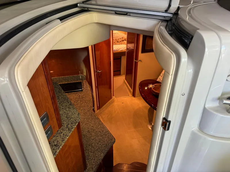Slide: The Image of Interior view of 2006 Sea Ray 38 Sundancer yacht, featuring a cozy cabin and kitchenette. - 22