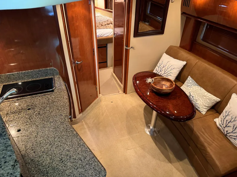 Slide: The Image of Interior of 2006 Sea Ray 38 Sundancer yacht with elegant seating and kitchenette. - 23