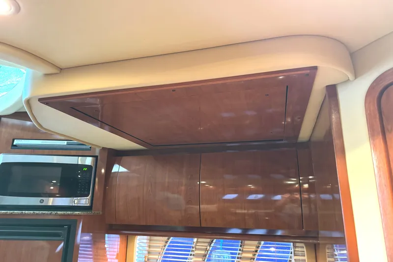 Slide: The Image of Interior of 2006 Sea Ray 38 Sundancer with wooden cabinets and microwave. - 28