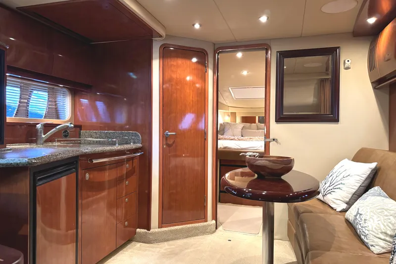 Slide: The Image of Luxurious interior of 2006 Sea Ray 38 Sundancer yacht with kitchen and seating area. - 31