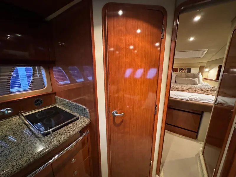 Slide: The Image of Interior of 2006 Sea Ray 38 Sundancer yacht with wood finishes and cozy bedroom. - 32