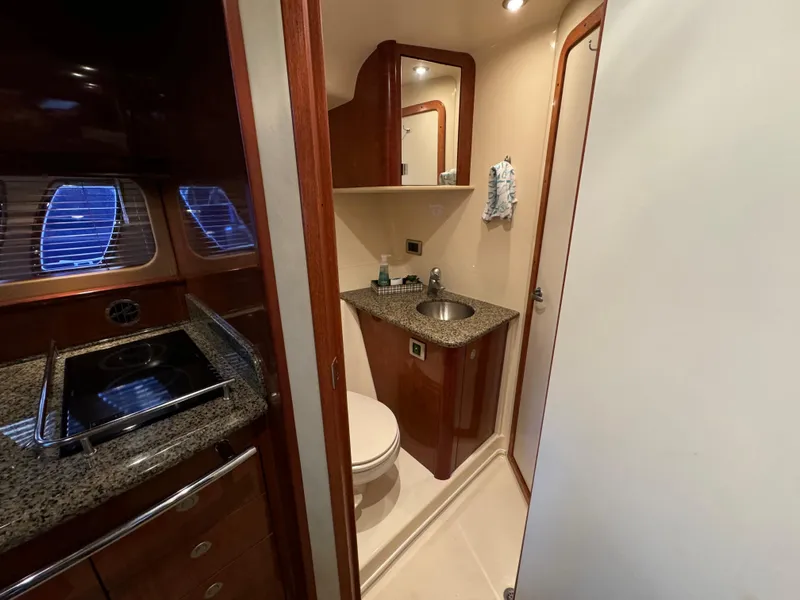 Slide: The Image of 2006 Sea Ray 38 Sundancer bathroom with granite countertops and wood cabinetry. - 33