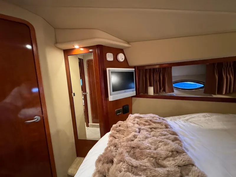 Slide: The Image of Luxurious cabin interior of 2006 Sea Ray 38 Sundancer yacht with cozy bedding and TV. - 37