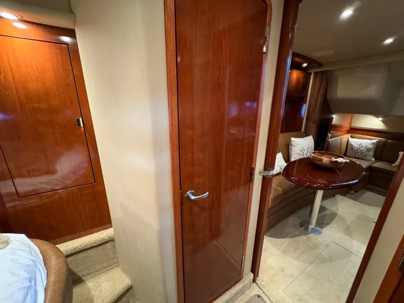 Slide: The Image of Interior of 2006 Sea Ray 38 Sundancer yacht with wood finishes and cozy seating area. - 44