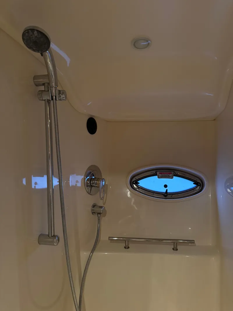 Slide: The Image of Shower area in 2006 Sea Ray 38 Sundancer yacht with oval window and chrome fixtures. - 47
