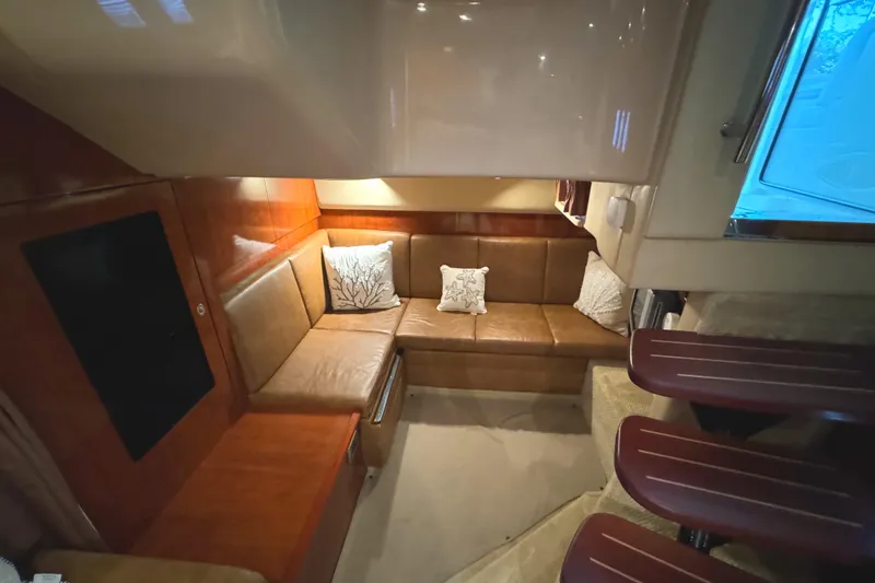 Slide: The Image of Interior of 2006 Sea Ray 38 Sundancer yacht with cozy seating area and cushions. - 48