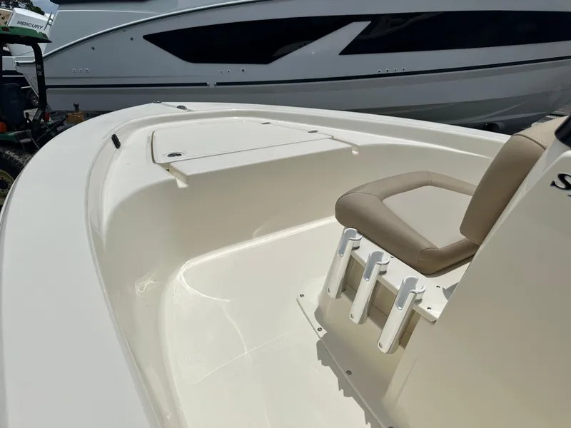Slide: The Image of 2025 Scout 177 Sport boat interior with seating and storage. - 11