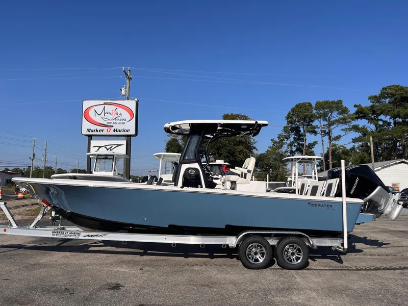The Image of 2025 Tidewater 2700 Carolina Bay boat on trailer at dealership, clear sky background. - 0