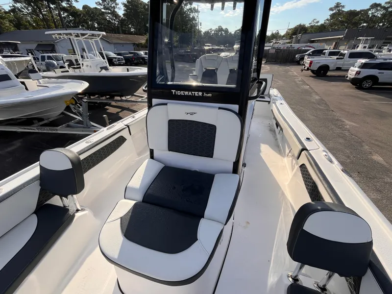Slide: The Image of 2025 Tidewater 2700 Carolina Bay boat interior with seating, parked in a marina. - 12