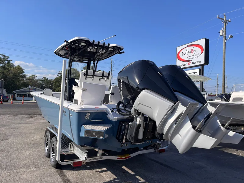 Slide: The Image of 2025 Tidewater 2700 Carolina Bay boat with dual engines on a trailer. - 2