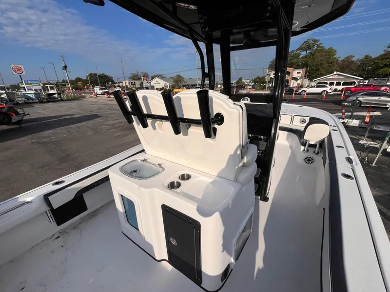 Slide: The Image of 2025 Tidewater 2700 Carolina Bay boat interior with rod holders and storage compartments. - 6