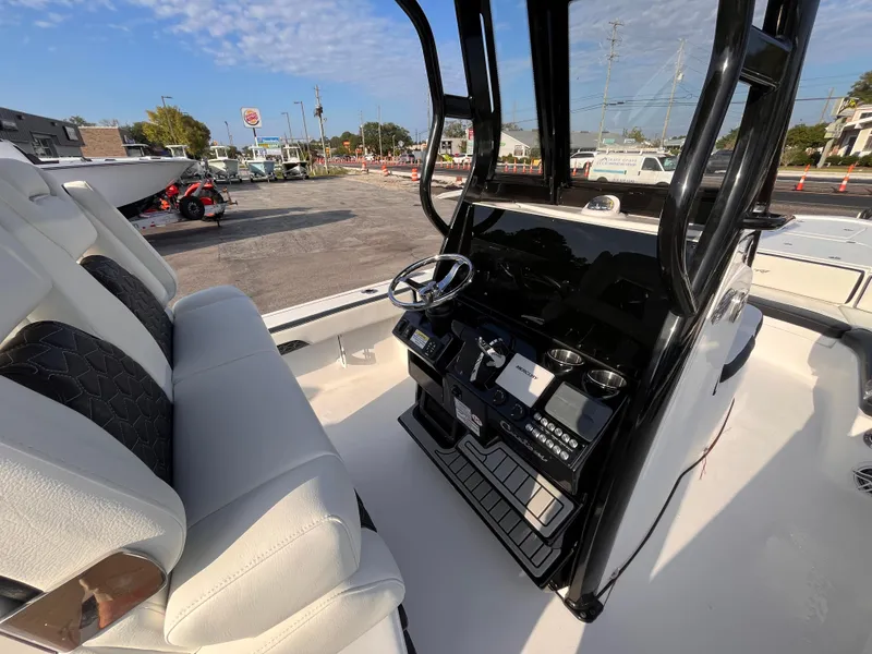 Slide: The Image of 2025 Tidewater 2700 Carolina Bay boat interior with steering console and seating. - 7