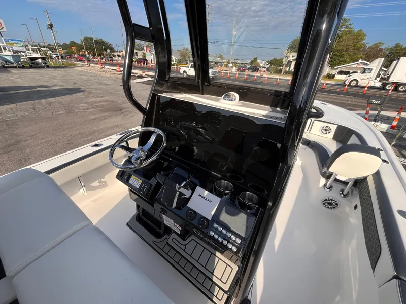 Slide: The Image of 2025 Tidewater 2700 Carolina Bay boat interior with steering console and seating. - 9