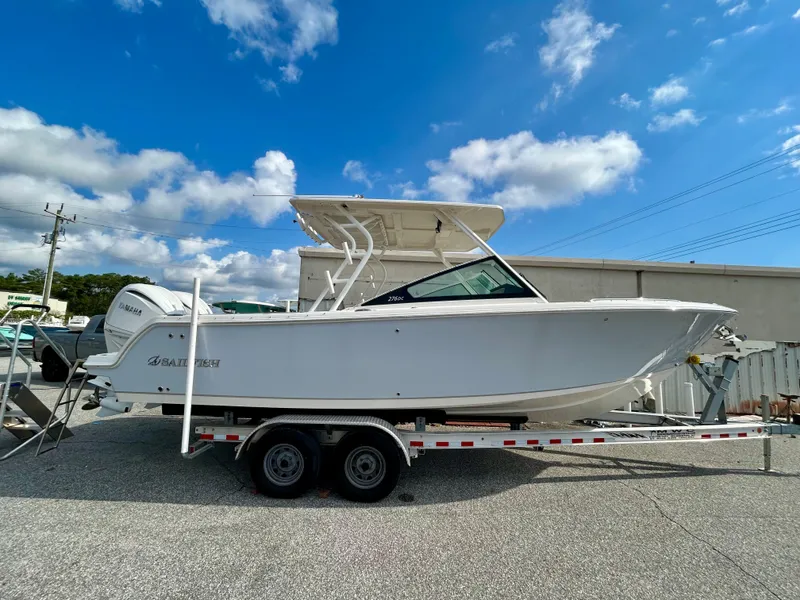 The Image of 2024 Sailfish 276 DC boat on trailer under blue sky. - 0