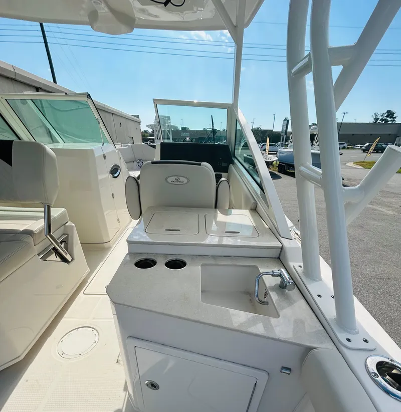 Slide: The Image of 2024 Sailfish 276 DC boat interior with seating and sink, showcasing modern design. - 10