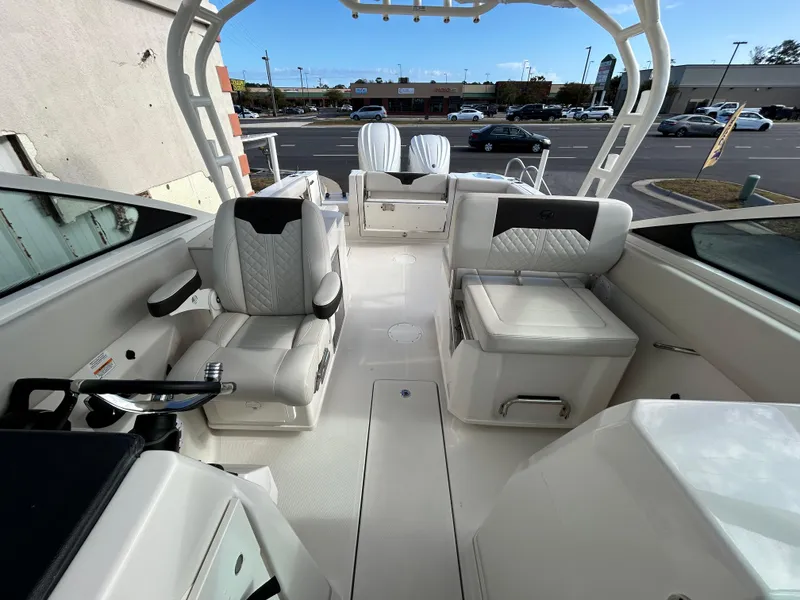 Slide: The Image of 2024 Sailfish 276 DC boat interior with modern seating and steering wheel. - 19