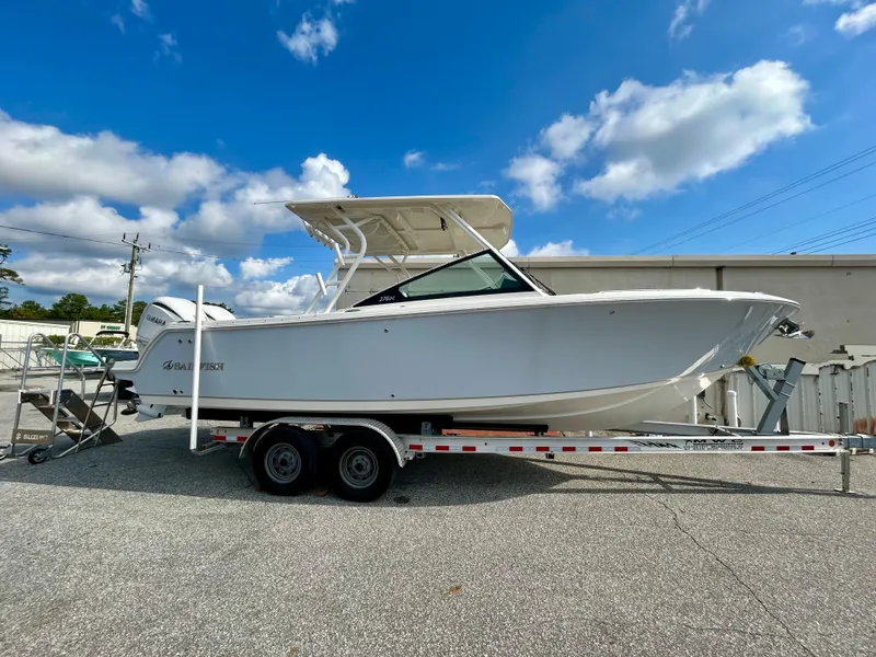 Slide: The Image of 2024 Sailfish 276 DC boat on trailer under blue sky. - 2