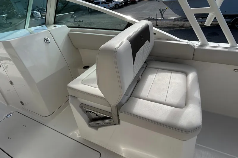 Slide: The Image of 2024 Sailfish 276 DC boat interior with white cushioned seating. - 23