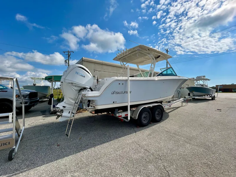 Slide: The Image of 2024 Sailfish 276 DC boat on trailer under blue sky. - 5